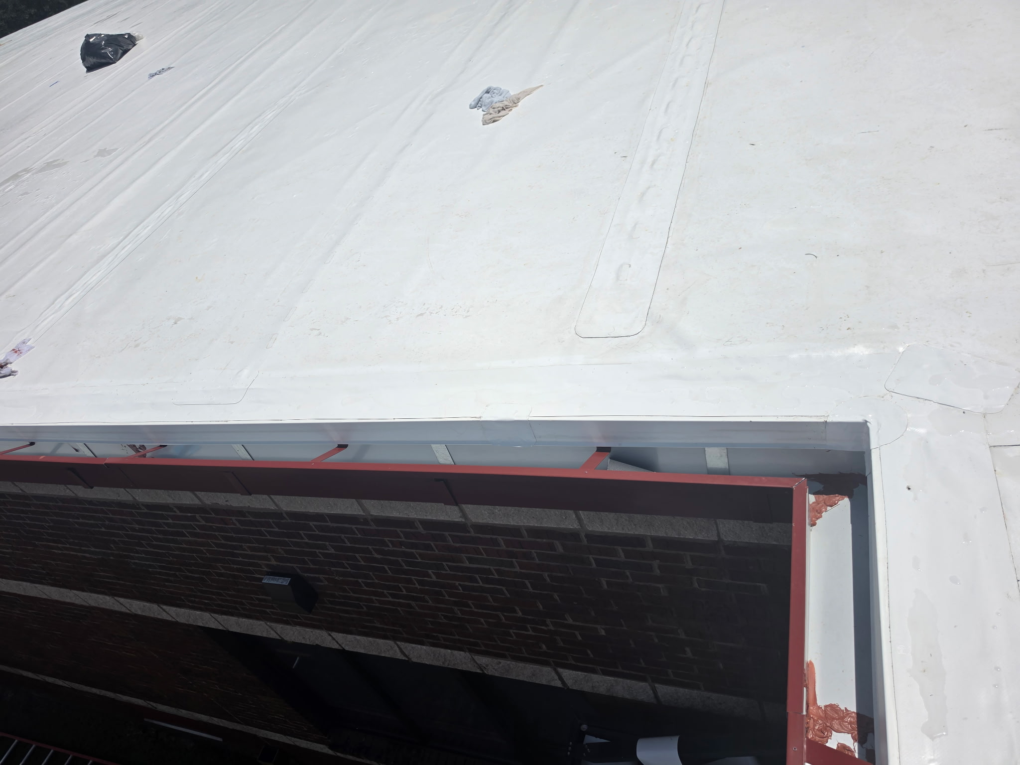 Aerial view of the New Midway Middle School roof — white PVC single-ply membrane wrapped over MPI Fabrication's perimeter edge metal and gutter system
